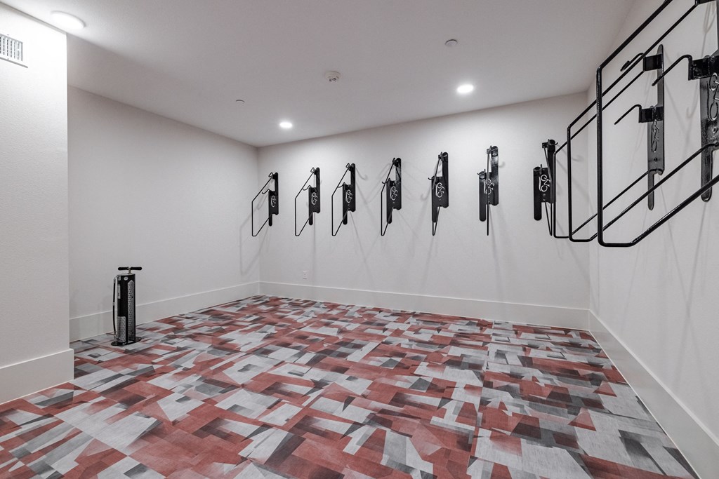 a large room with a wall of saddles on the wall and a floor covered