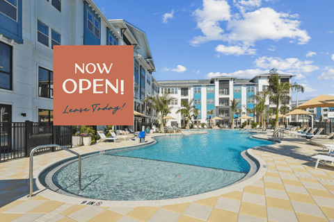 A pool area with a sign that says "NOW OPEN! Lease Today!"