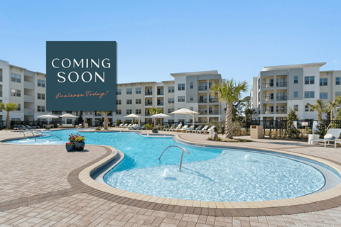 A pool area with a sign that says "Coming Soon" and "Prepare Today!" in front of apartment buildings.