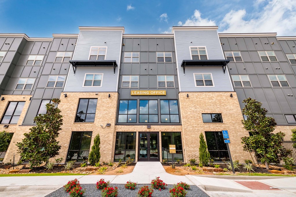 an exterior view of a building with a sidewalk in front of it
