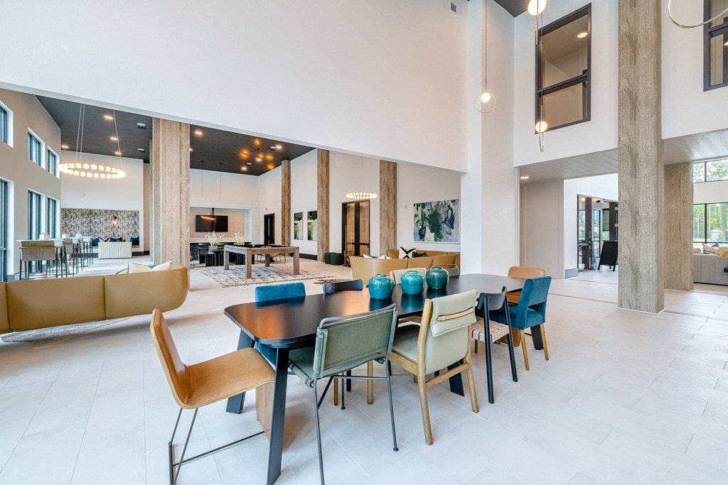 a dining room with a table and chairs and a living room
