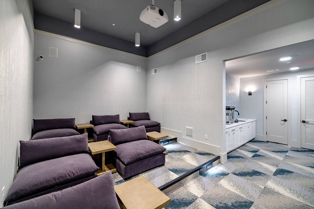 a large room with couches and a sink and a mirror