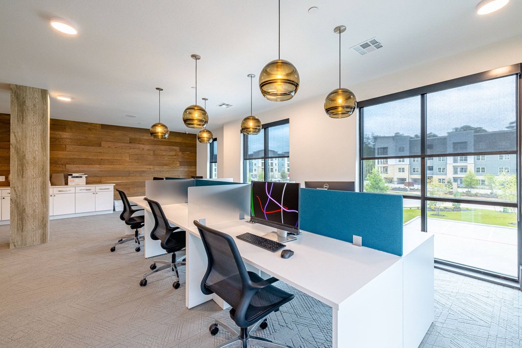 a modern office with a long white desk and a window
