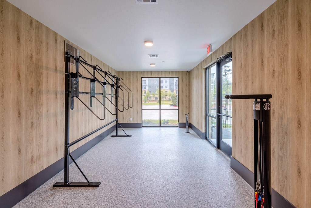 a workout room with a treadmill and a wall with wood paneling