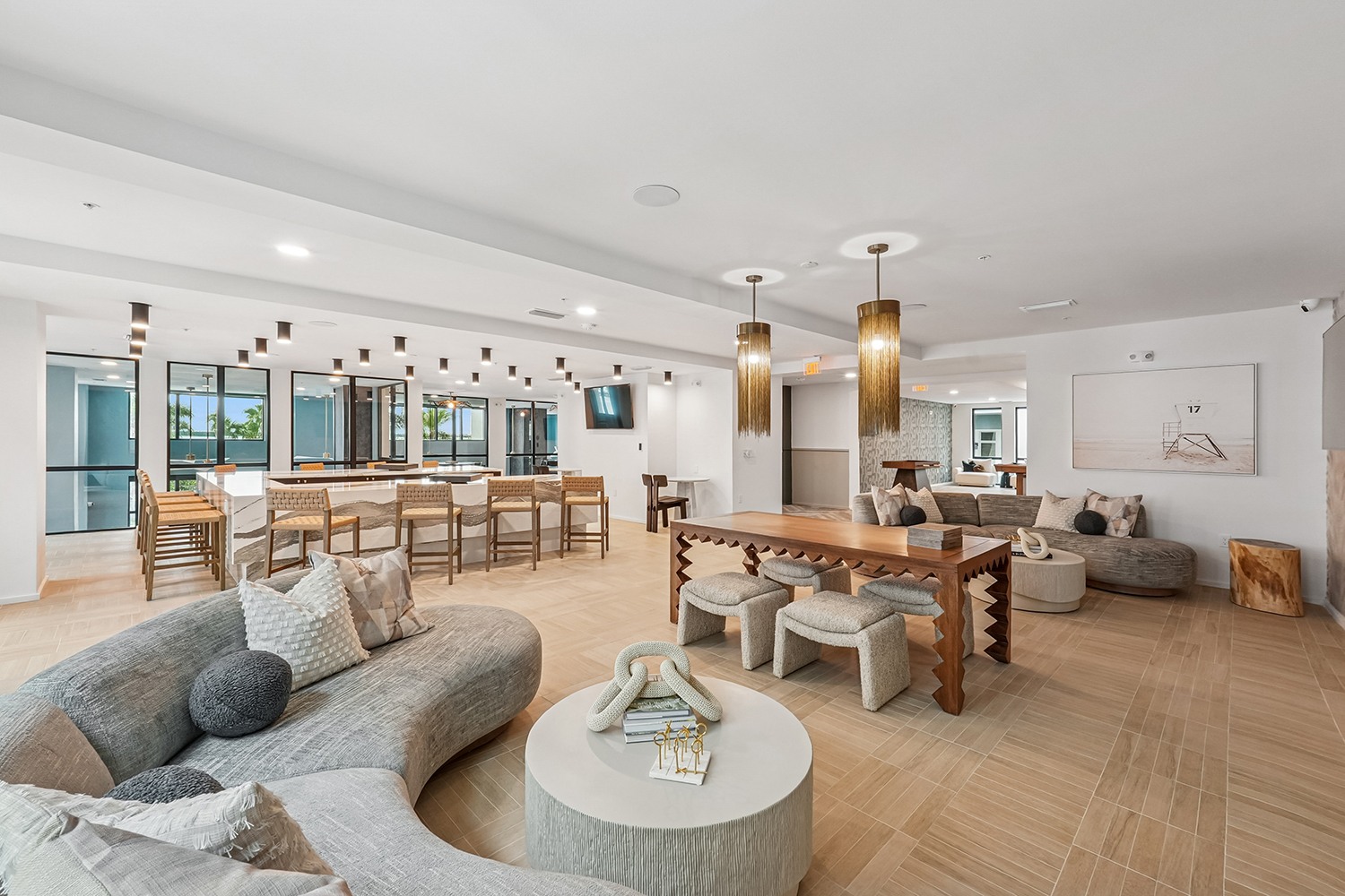 A modern living room with a grey sofa and wooden floors.