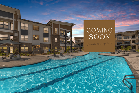 A pool in front of a building with a sign that says "Coming Soon".