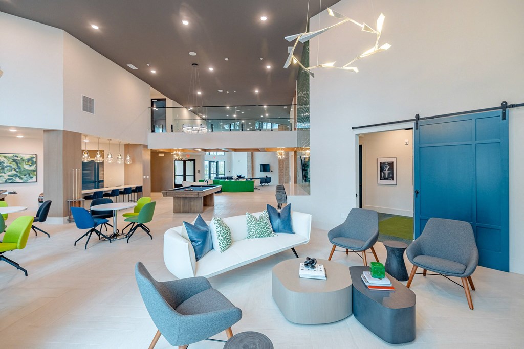 a large living room with blue chairs and a white couch