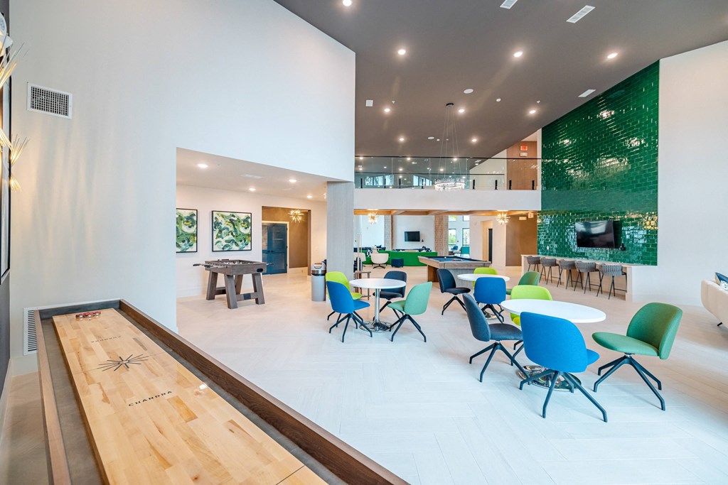 a communal area with tables and chairs and a fireplace