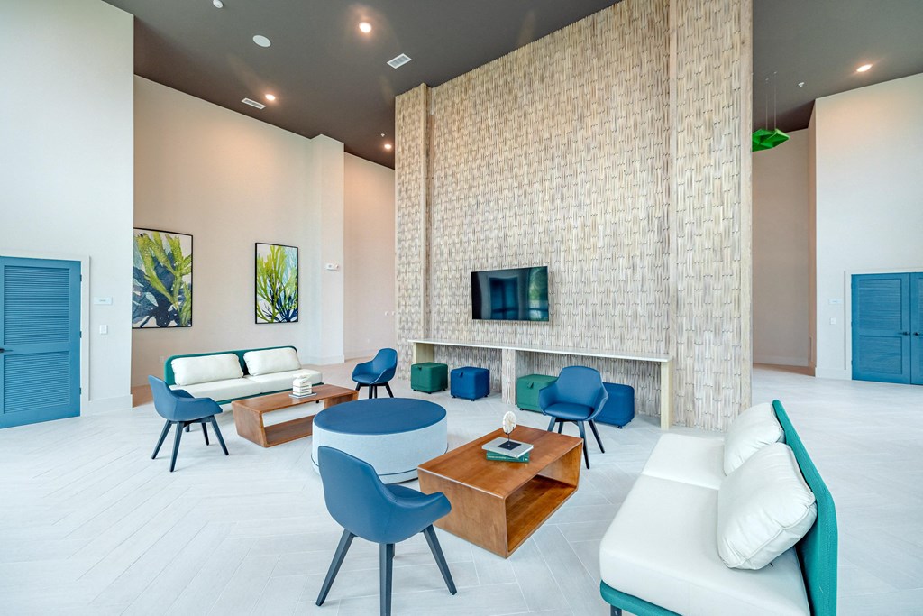 a living room with a couch table and chairs and a fireplace