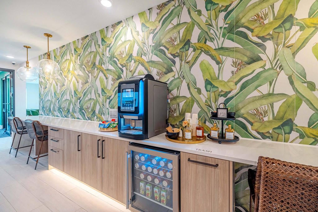 a kitchen with a coffee machine and a wall mural