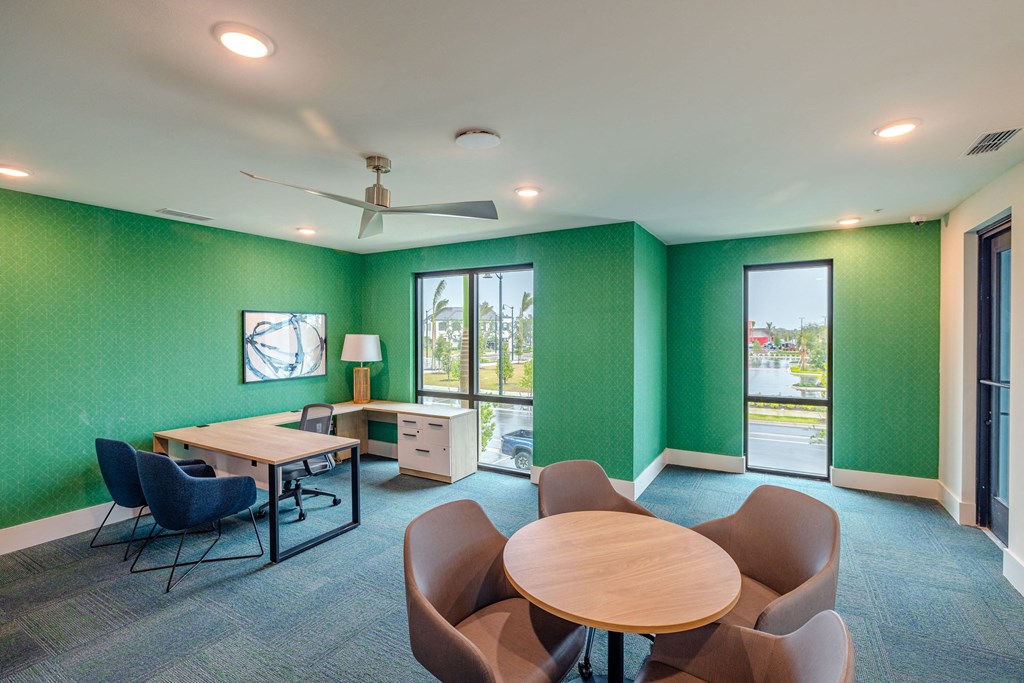 a conference room with green walls and a table and chairs