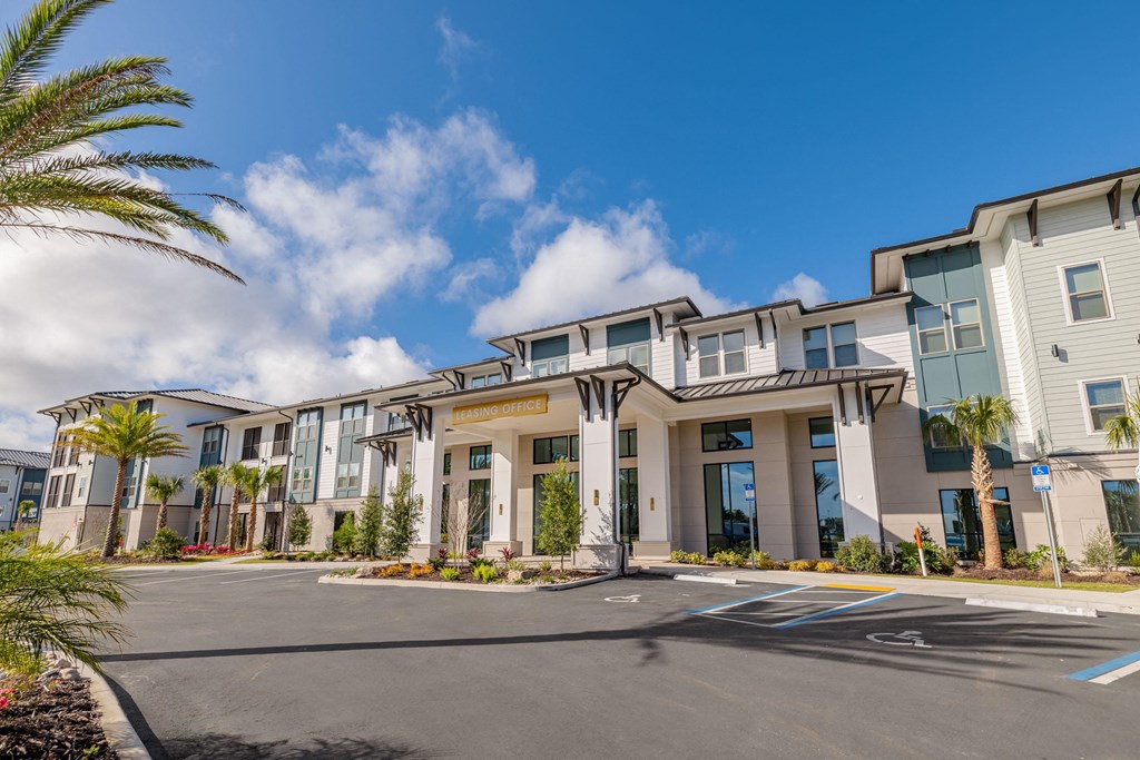 a building with a street in front of it with palm trees