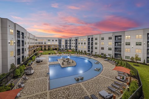 an aerial view of an apartment complex with a large swimming pool