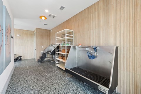 A kitchen with a stainless steel refrigerator and wooden walls.