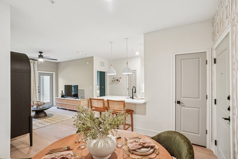 Dining Area and Kitchen Peninsula with Seating Space and View into Living Room