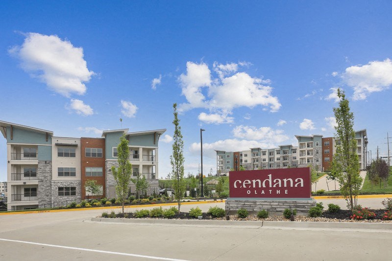 an empty parking lot in front of an apartment building