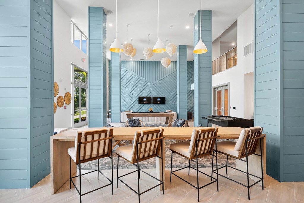 a dining area with a table and chairs and a living room with a fireplace