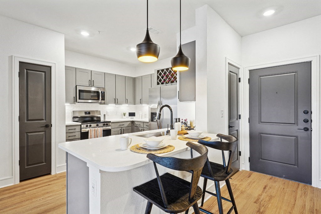 Kitchen with Quartz Countertop and Stainless Steel Appliances.