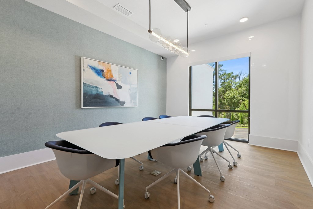 a conference room with a white table and chairs