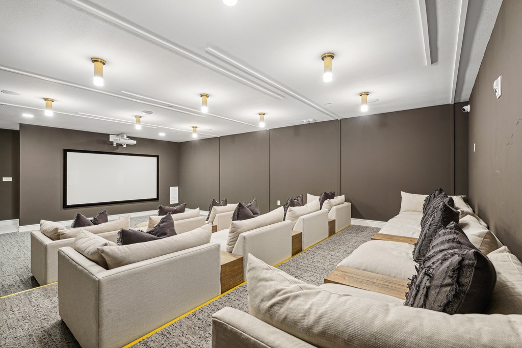 A modern home theater with a large screen and comfortable seating.