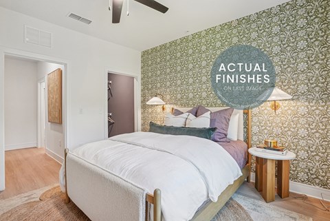 A bedroom with a large bed and a ceiling fan.