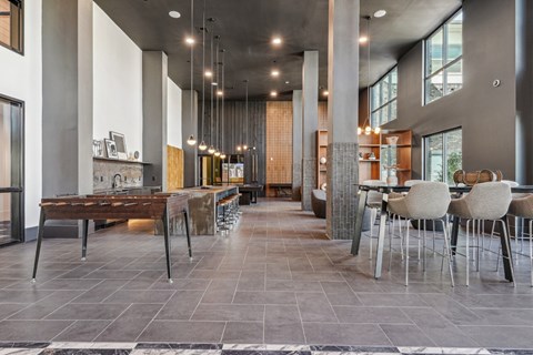 A modern dining area with a long table and chairs.