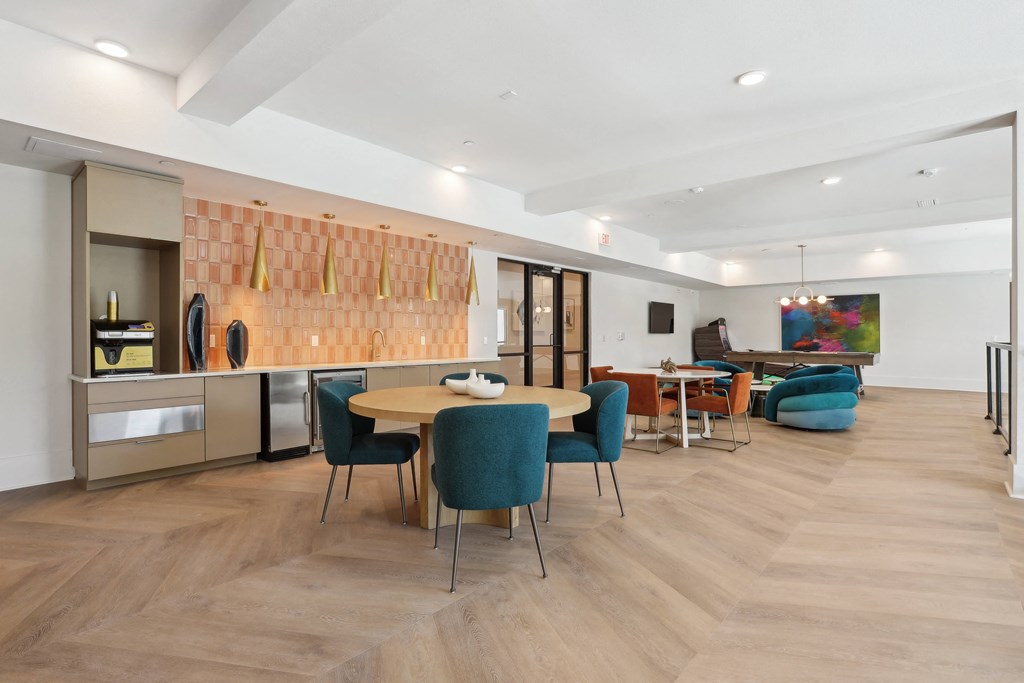 a living room and dining room with a table and chairs