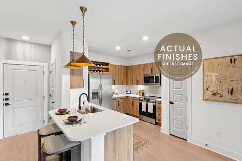 A modern kitchen with a white island and wooden cabinets.