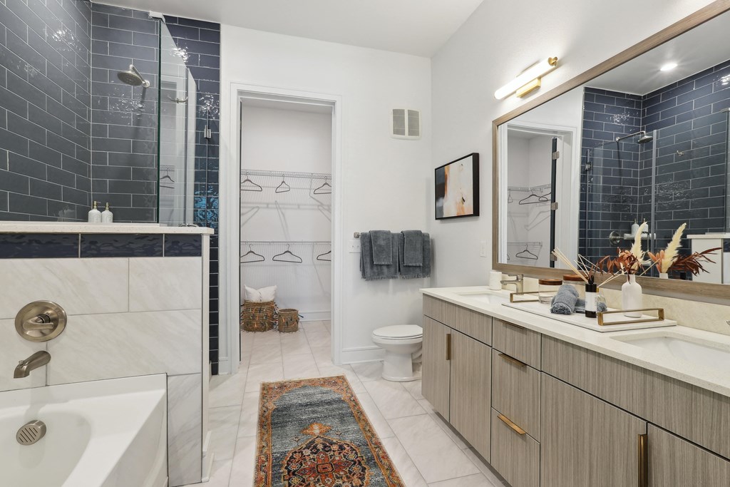 a bathroom with a shower and a sink and a mirror