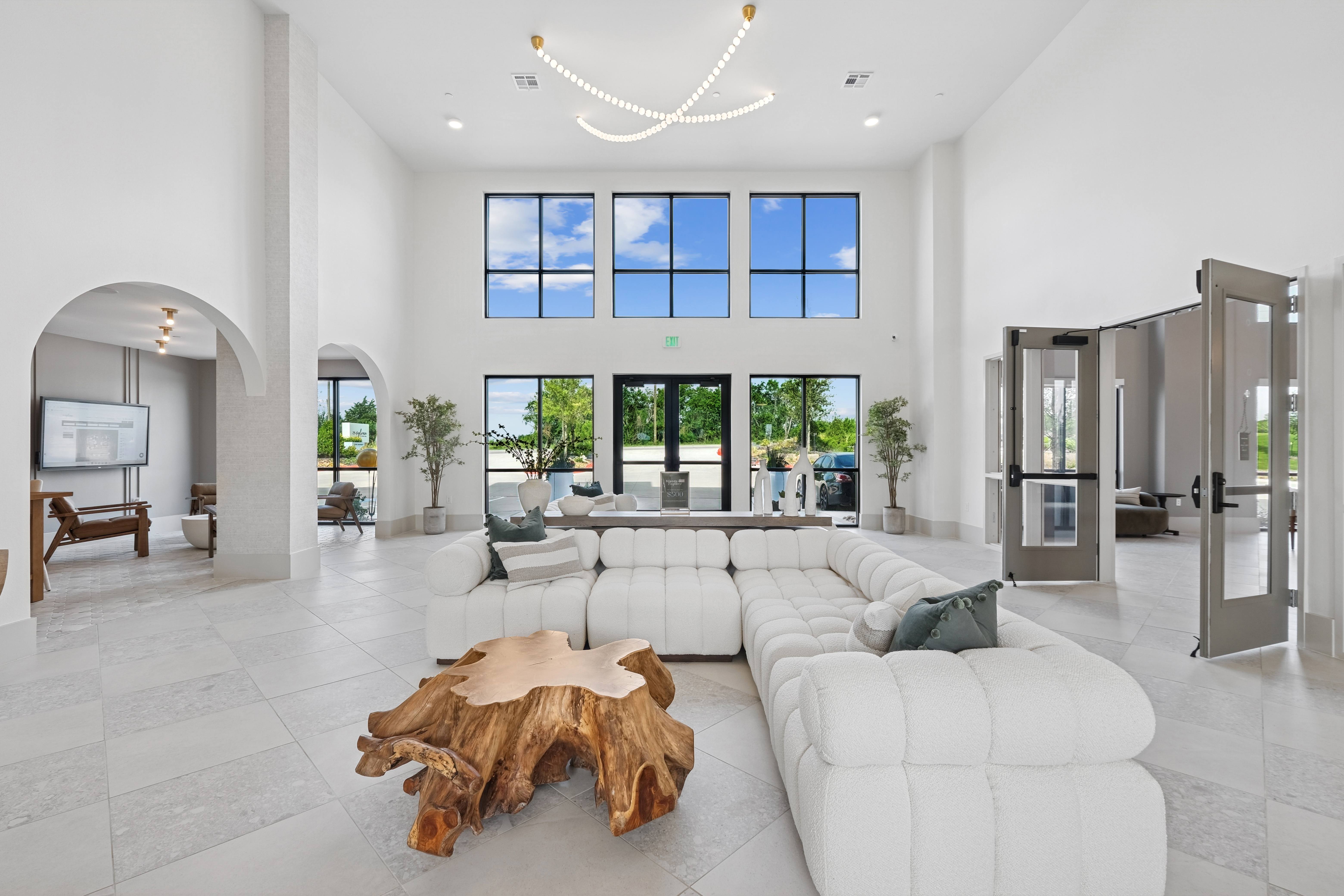 A modern living room with a white sofa and a wooden coffee table.