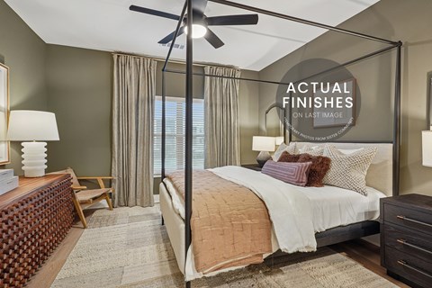 A bedroom with a large bed and a ceiling fan.
