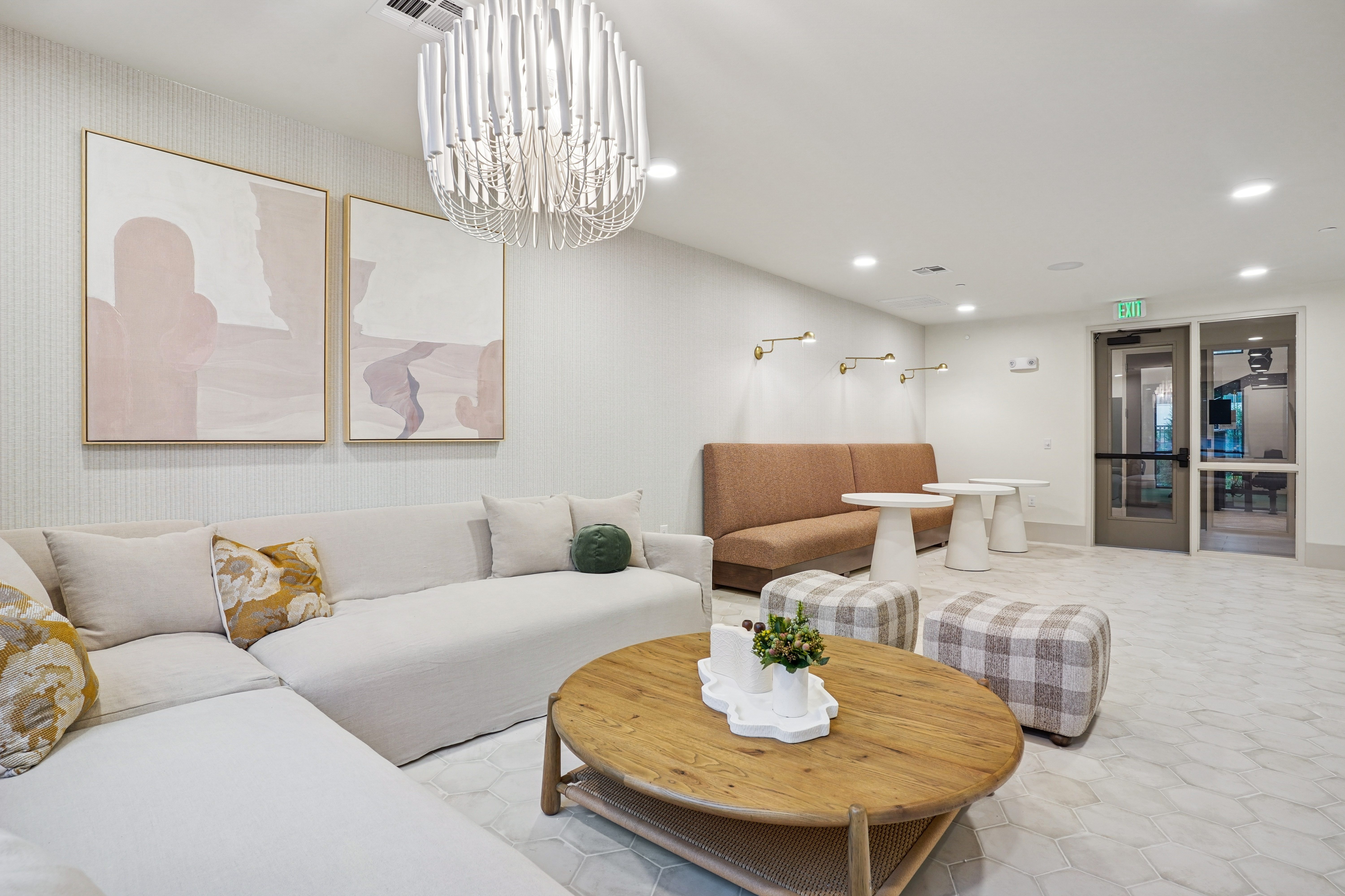 A modern living room with a wooden coffee table and a chandelier.