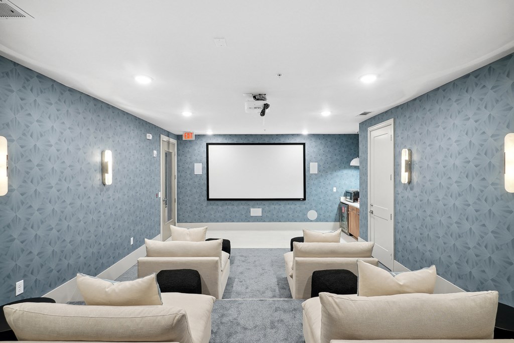 a large living room with couches and a projector