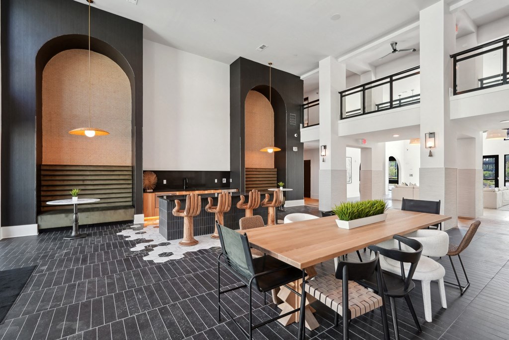 a large dining room with a wooden table and chairs
