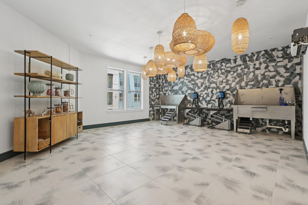 the living room has a marble floor and a fireplace and chandeliers
