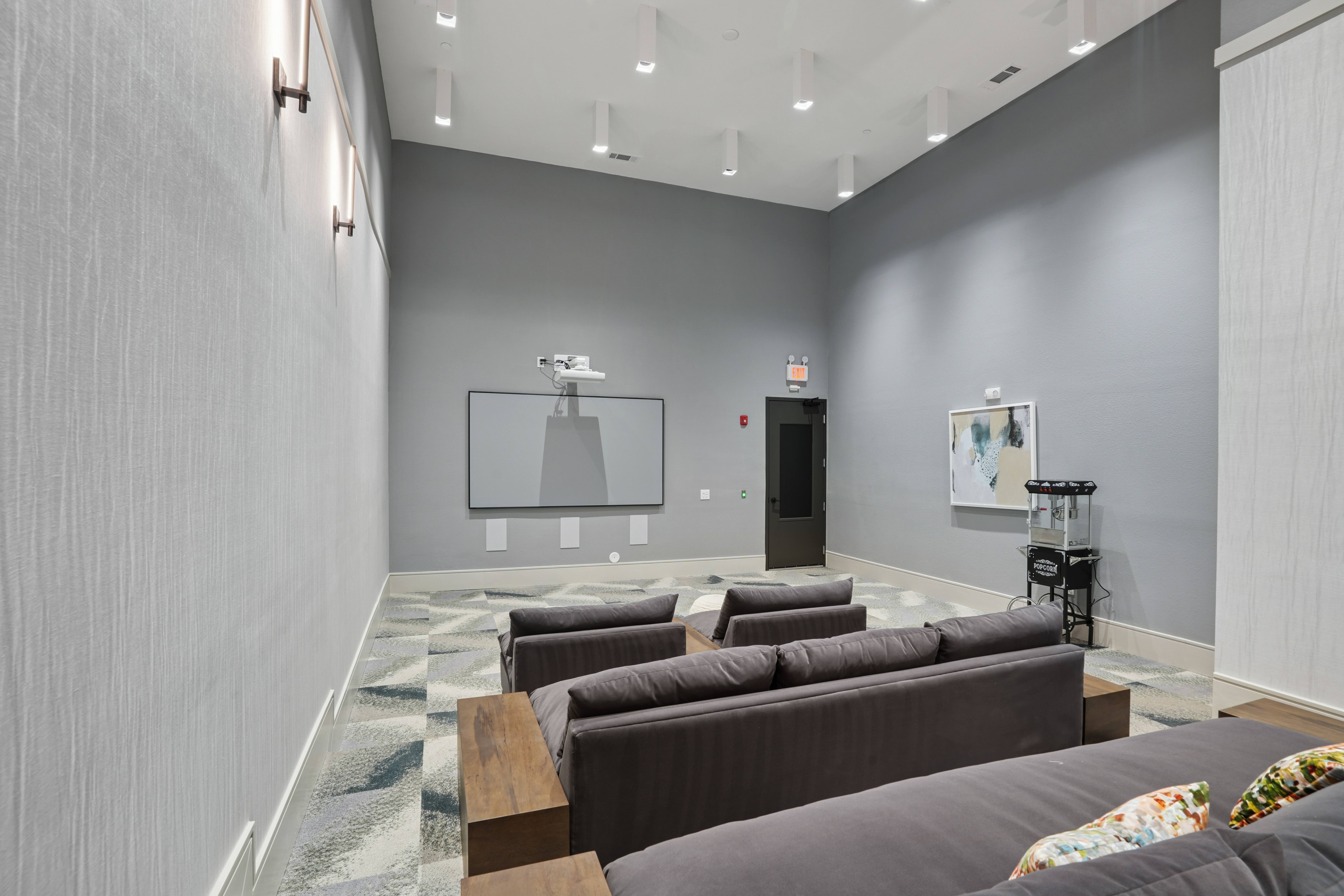 A modern living room with a grey couch and a television.