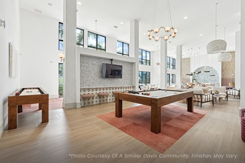 A room with a pool table and a couch.