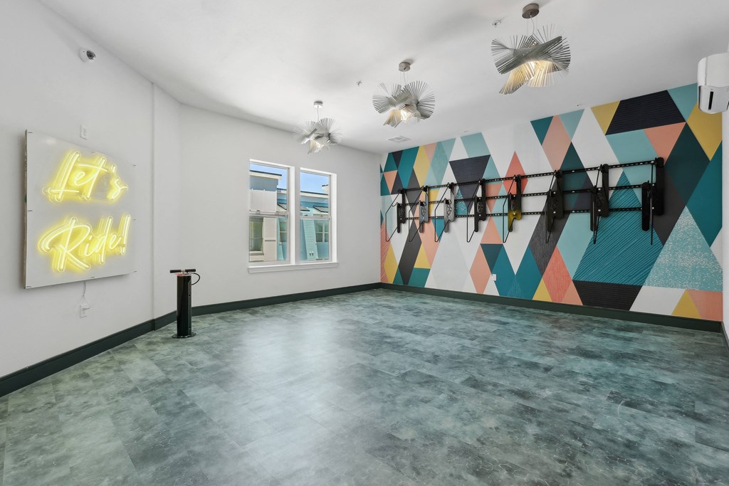 the interior of a room with a colorful mural on the wall and a cement floor