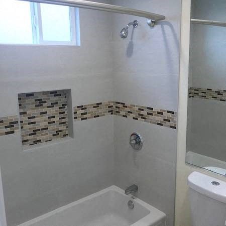A white bathroom with a shower and a toilet.