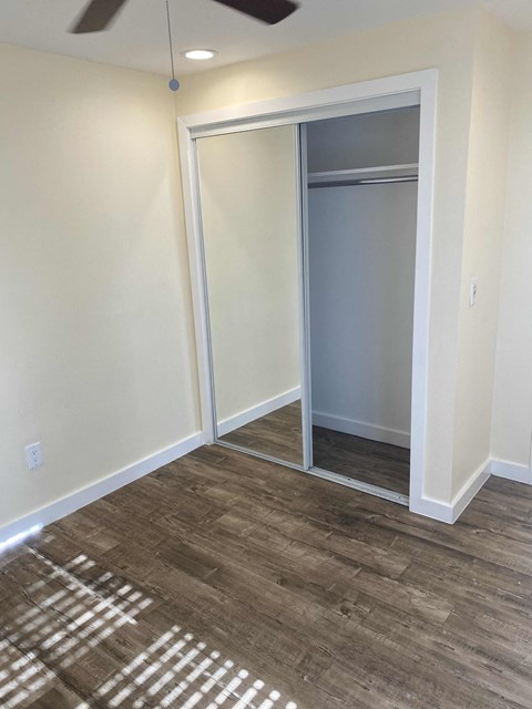 A room with a sliding door and a ceiling fan.