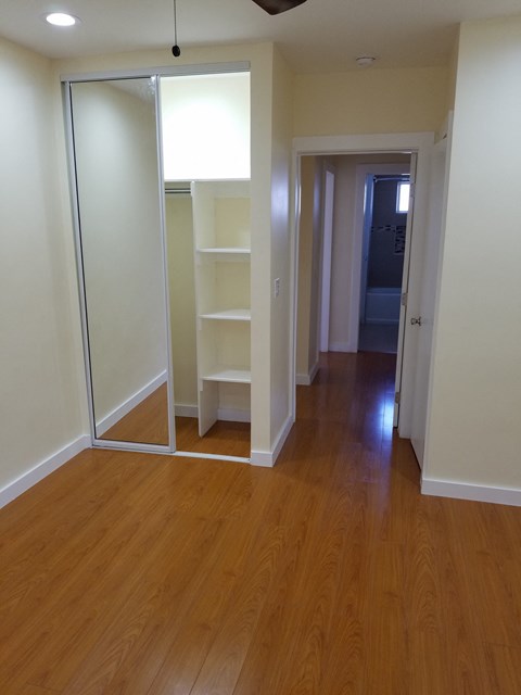 A room with a sliding door and shelves.