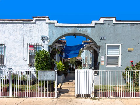 A white archway with a blue tarp in the background.