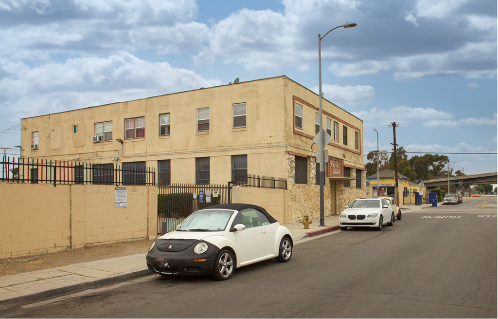 A white car is parked on the side of a street.