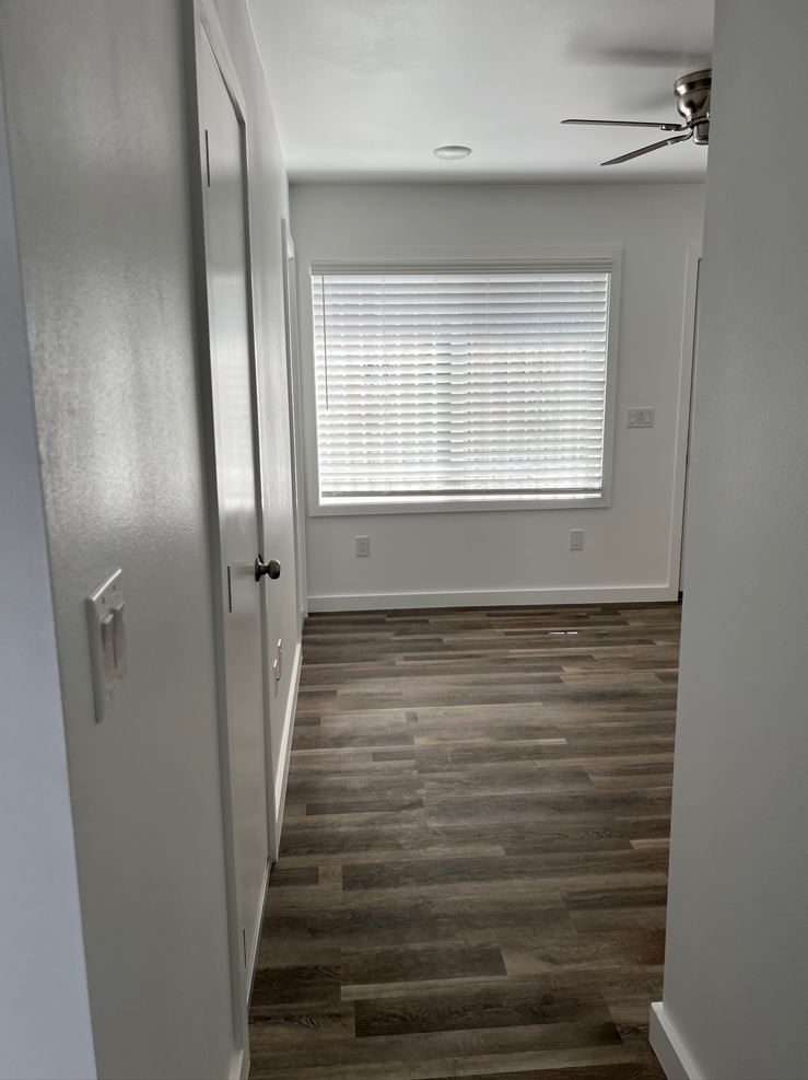 a small hallway with a window and a door