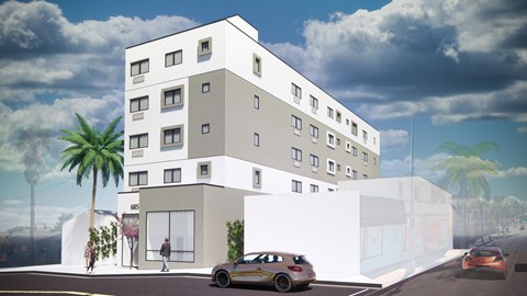A white building with a car parked in front of it.