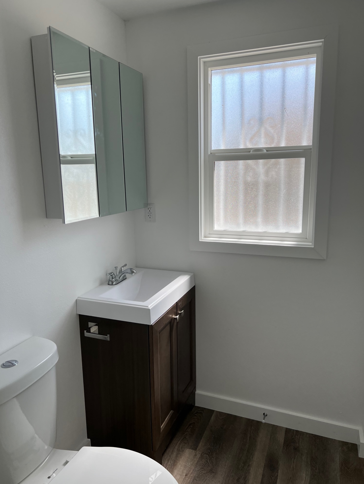 a small bathroom with a sink toilet and a mirror