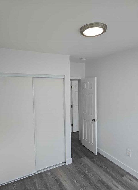 A white door is open to a hallway.