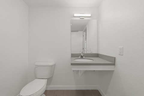 A white toilet sits next to a sink in a small bathroom.