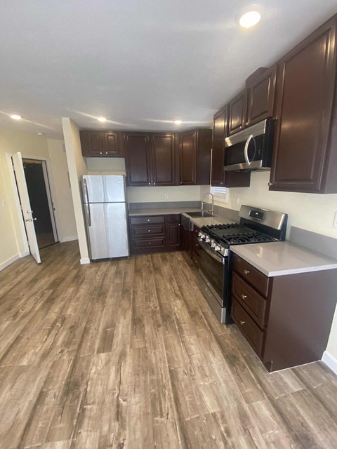 A kitchen with brown cabinets and a white fridge.