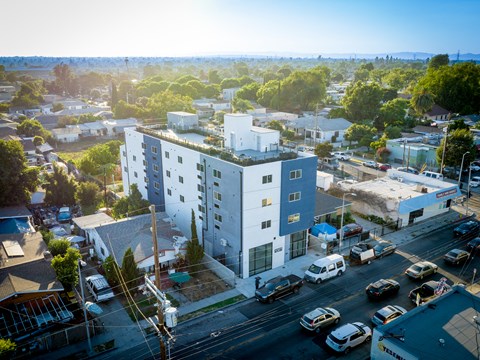 an aerial view of a large white building in a city
